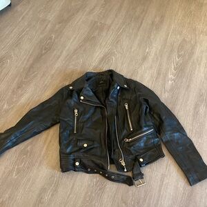 Faux black leather motorcycle moto jacket. Wear at the neck on the back.